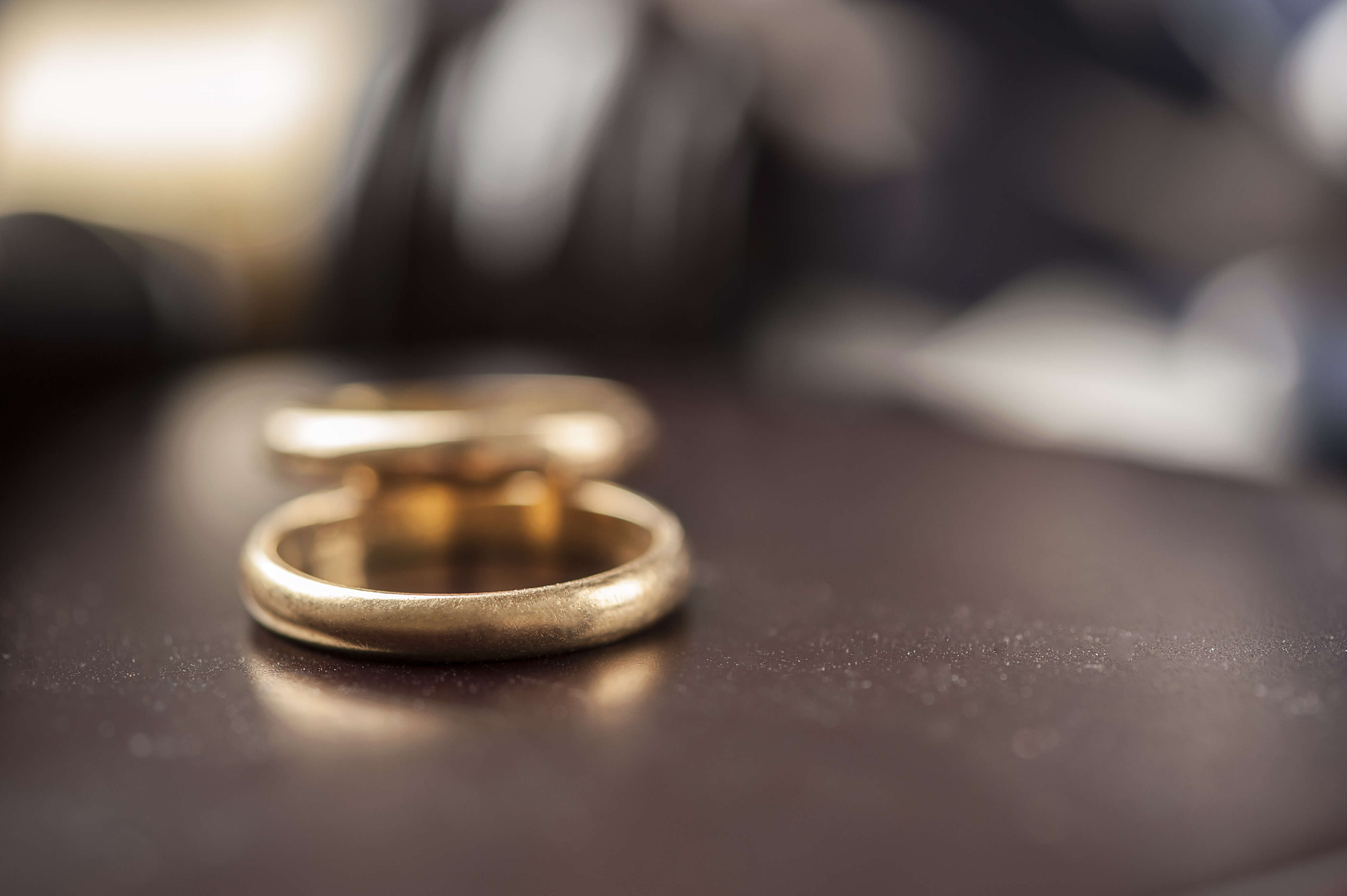 weddings rings placed on a desk at a divorce law firm on Long Island