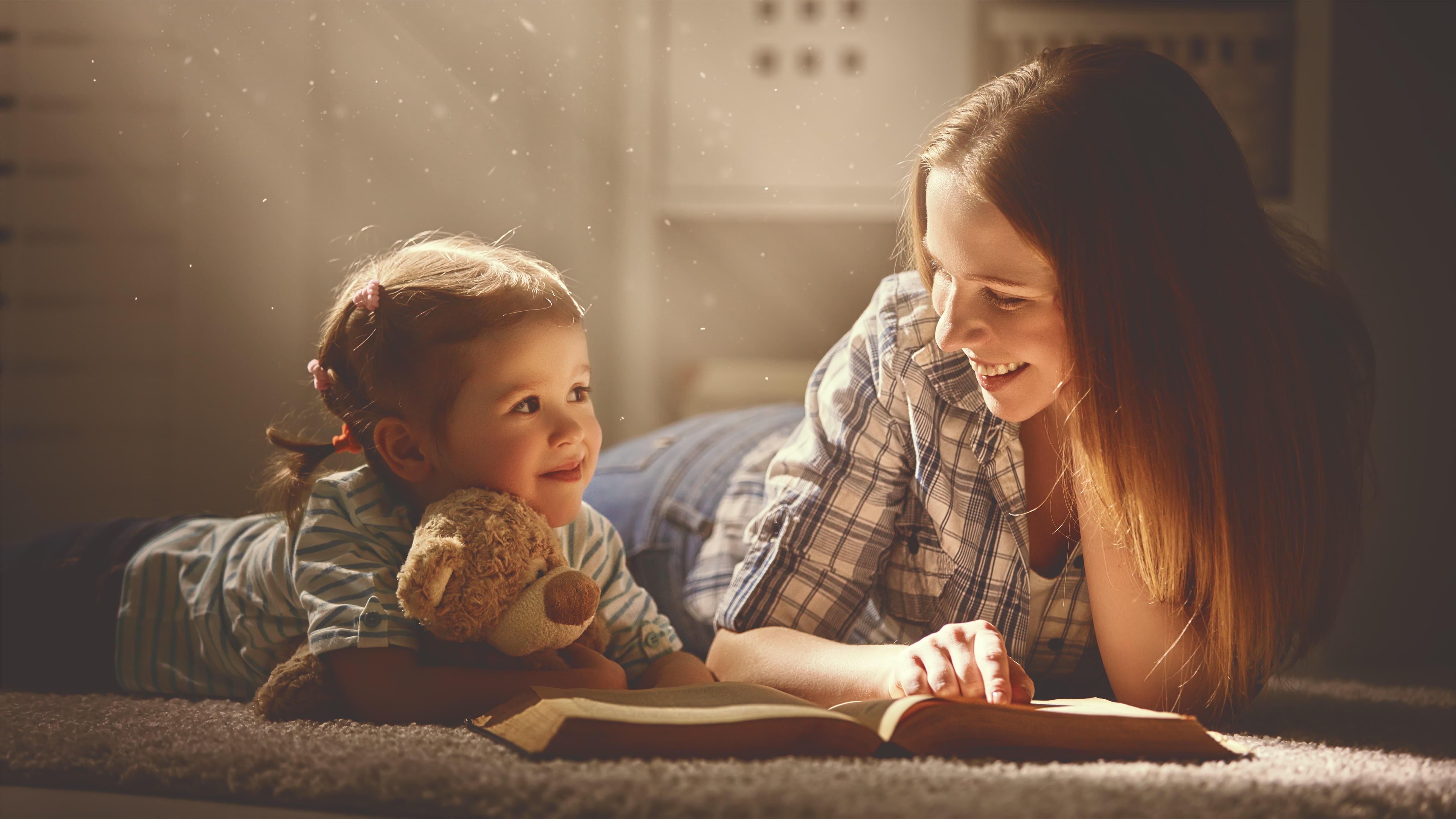 parent with custody reading a book together with her child